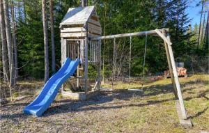 a playground with a blue slide in a yard at Amazing Apartment In Skrblacka With Kitchen in Skärblacka