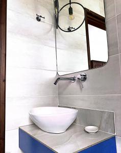 a bathroom with a white sink and a mirror at Harmony Seaside Pelion in Platanias