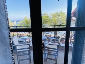 a view of two chairs and a table from a window at Harmony Seaside Pelion in Platanias