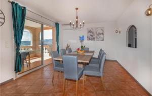 une salle à manger avec une table et des chaises bleues dans l'établissement 3 Bedroom Nice Apartment In Bastelicaccia, à Bastelicaccia