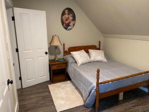 a bedroom with a bed and a table with a lamp at Fabulous Barre Apts! in Barre