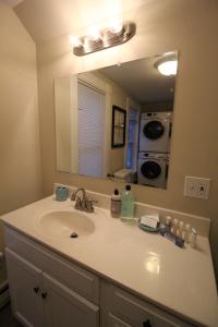 a bathroom with a sink and a mirror at Fabulous Barre Apts! in Barre
