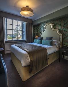 A bed or beds in a room at Washingborough Hall Hotel