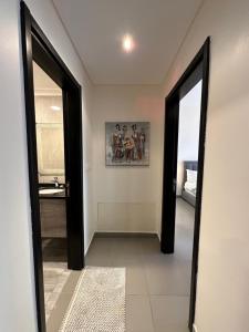 a hallway with two doors and a painting on the wall at Dead Sea view Elite apartment Samara Resort traveler award 2026 in Sowayma