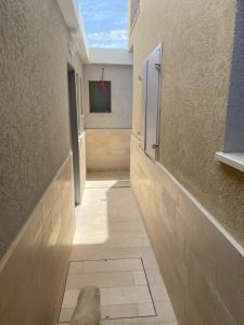 a hallway of a bathroom with a window and a rock on the floor at בוטיק צ'יל אאוט - Boutique Chill Out in Eilat