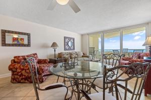 a living room with a glass table and chairs at Perdido Sun 610 in Perdido Key