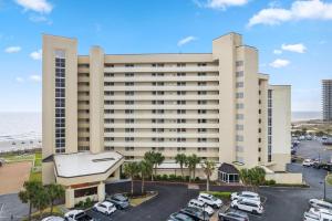 a large building with cars parked in a parking lot at Perdido Sun 610 in Perdido Key