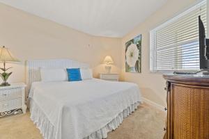 a bedroom with a white bed and a window at Perdido Sun 610 in Perdido Key