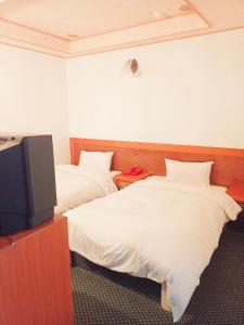 Un ou plusieurs lits dans un hébergement de l'établissement Fortune Hotel