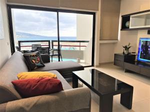 a living room with a couch and a television at Chalet at Aqualand Resort in Batroûn