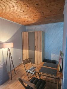 een woonkamer met een tafel en een stoel bij Wild Beauty house Skadar lake in Cetinje