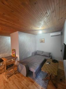 een slaapkamer met een bed en een houten plafond bij Wild Beauty house Skadar lake in Cetinje