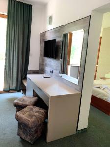 a hotel room with a vanity and a mirror at Hotel Opal in Primorsko