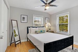 a bedroom with a bed and a ceiling fan at Sunny & Spacious 3-Bedroom Apt - Carmen 5640 & 5641 rep in Chicago