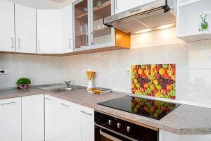 a kitchen with a painting of fruit on the counter at Apartment Ana-Marija in Makarska
