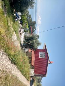 a red house on the side of a hill at Kır evi in Mugla