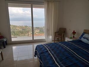 a bedroom with a bed and a large window at Kır evi in Mugla