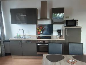 a kitchen with a sink and a stove top oven at Stadt-Land-Fluss in Wickede (Ruhr)