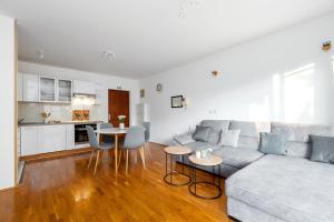 a white living room with a couch and a table at Apartment Ana-Marija in Makarska