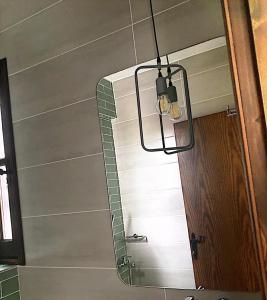 a light hanging over a mirror in a room at Harmony Seaside Pelion in Platanias