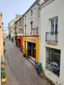 an empty street with buildings and a bike parked on the street at La Palme de Retz in Pornic