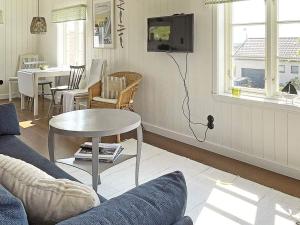 a living room with a couch and a table at Holiday home BLEKET II in Bleket