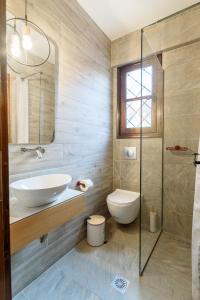 a bathroom with a sink and a toilet at Harmony Seaside Pelion in Platanias