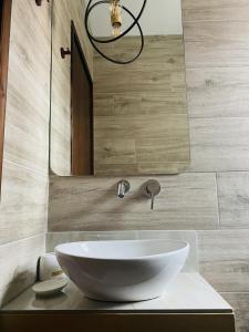 a bathroom with a white sink and a mirror at Harmony Seaside Pelion in Platanias