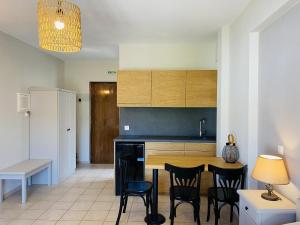 a kitchen with a table and chairs in a room at Harmony Seaside Pelion in Platanias
