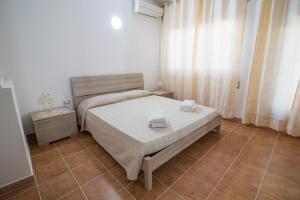 1 dormitorio con 1 cama con 2 toallas en Casa Wendy, en SantʼAntìoco