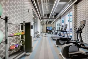 a gym with rows of treadmills and ellipticals at aloft Hotel Milwaukee Downtown in Milwaukee