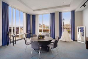 a room with a table and chairs and a wedding dress at aloft Hotel Milwaukee Downtown in Milwaukee