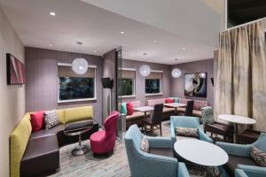 a waiting room with couches and tables and chairs at Residence Inn by Marriott Spartanburg Westgate in Spartanburg