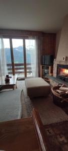 a living room with a bed and a fireplace at Appartement au pied des télécabines in La Tzoumaz