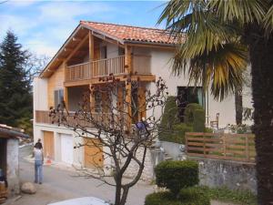 a woman standing in front of a house at Haras Picard Du Sant Le Chalet in Lasserre