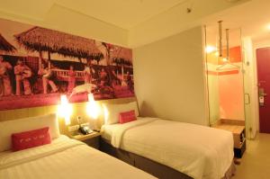 Postel nebo postele na pokoji v ubytování favehotel Cimanuk Garut