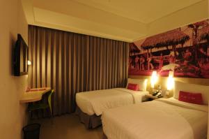 Postel nebo postele na pokoji v ubytování favehotel Cimanuk Garut