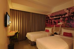 Postel nebo postele na pokoji v ubytování favehotel Cimanuk Garut
