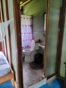 a small bathroom with a toilet and a sink at Ecohotel Bahía Terco in Nuquí