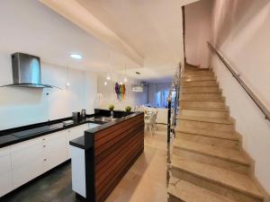 a kitchen with a staircase leading up to a living room at Casa Maia - cosy holidays in Benidorm in Cala de Finestrat