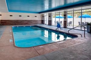 a large swimming pool with blue water in a building at Fairfield Inn & Suites by Marriott Douglas in Douglas
