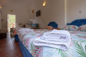 a bedroom with a bed with towels on it at Family Apartments Vukcevic in Čanj