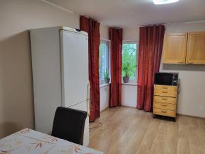 a room with a table and a cabinet and a window at Viva Apartment Nõmme in Tallinn +9 photos