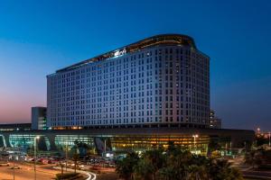 a large building with a lot of windows at Aloft Abu Dhabi in Abu Dhabi
