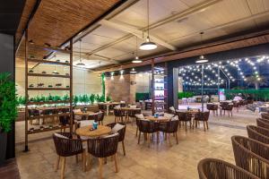 a restaurant with wooden tables and chairs and lights at Aloft Abu Dhabi in Abu Dhabi