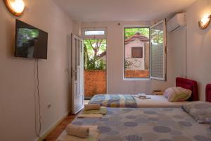 Postel nebo postele na pokoji v ubytování Family Apartments Vukcevic