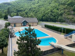 an overhead view of a swimming pool with a slide at Chalet Sanset in Gèdre