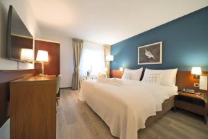 Кровать или кровати в номере Tulip Inn Beaulieu Lausanne