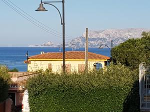a yellow house with a view of the ocean at CASA MAESTRALE - Vista mare Pittulongu - Sardegna - IUN R2217 in Olbia