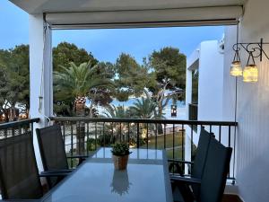 a table and chairs on a balcony with a view at Elena Playa Sol in Alcudia
